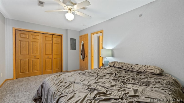 carpeted bedroom featuring a closet, visible vents, ceiling fan, electric panel, and baseboards