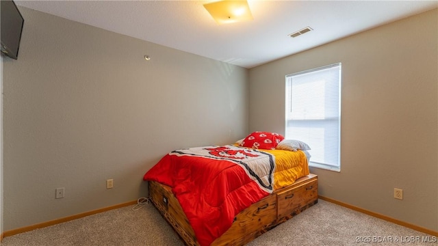 bedroom featuring carpet flooring, visible vents, and baseboards