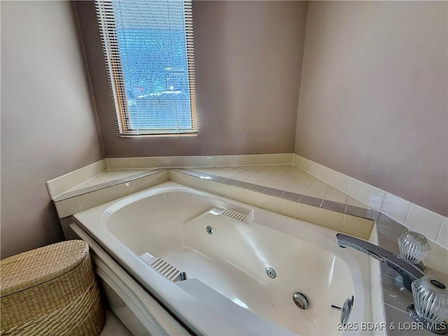 bathroom with a tub with jets