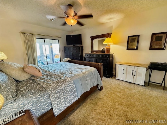 bedroom featuring access to outside, visible vents, light colored carpet, and a textured ceiling