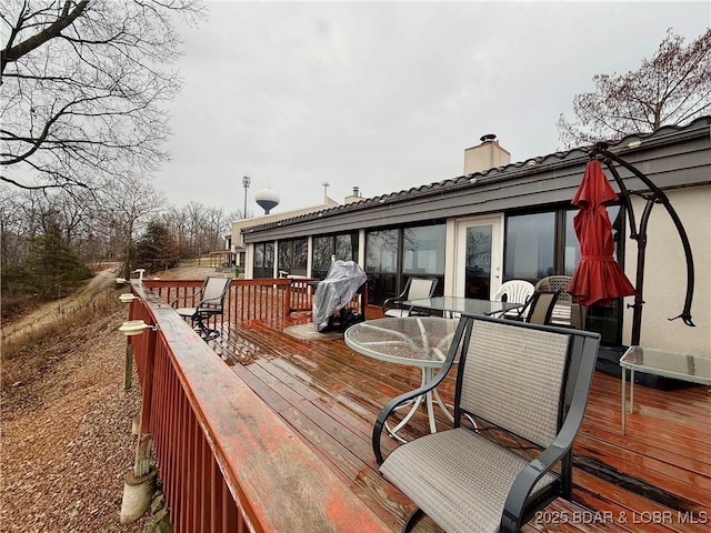 wooden terrace featuring outdoor dining area