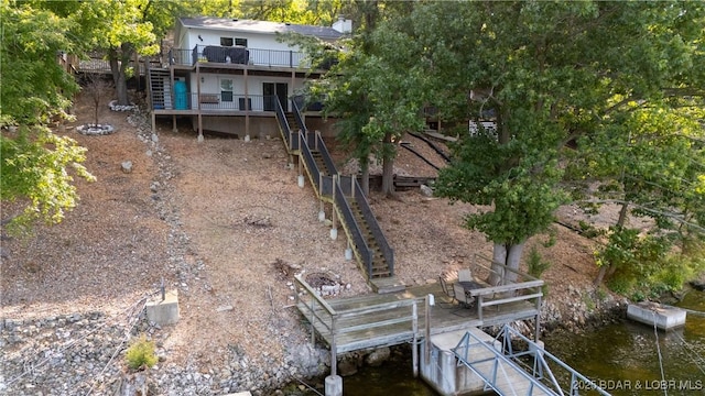 back of property with stairs and a deck