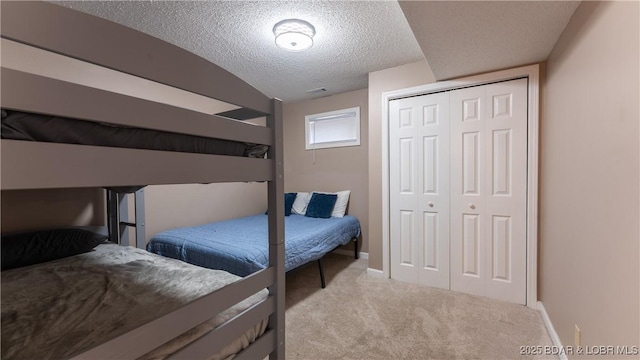 bedroom with baseboards, lofted ceiling, a textured ceiling, carpet floors, and a closet