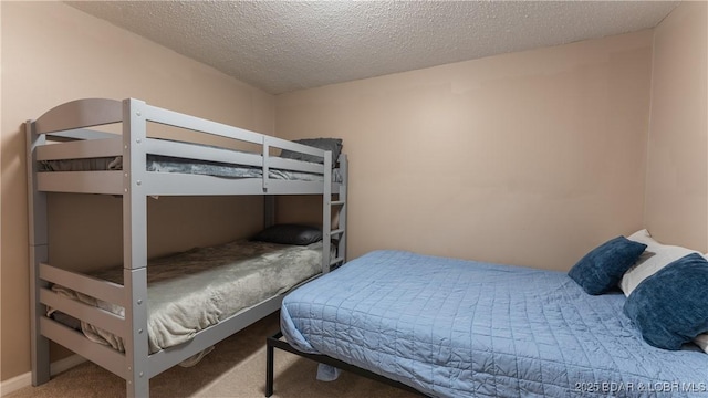 bedroom featuring carpet and a textured ceiling