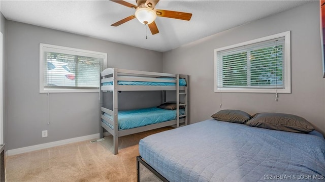 bedroom featuring ceiling fan, baseboards, and carpet flooring