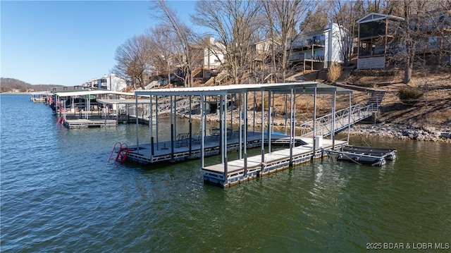 dock area with stairway and a water view