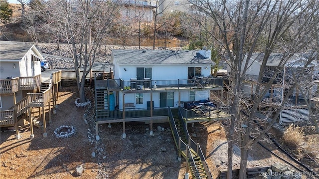 back of property featuring a deck and stairway