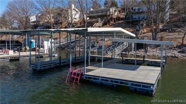 dock area with stairway and a water view