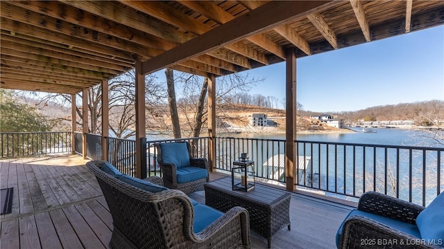 wooden deck with outdoor lounge area and a water view