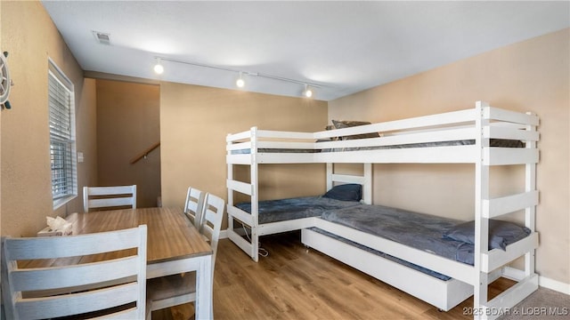 bedroom with wood finished floors and visible vents