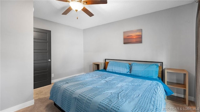 carpeted bedroom featuring a ceiling fan and baseboards