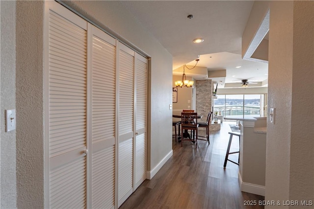 hall with an inviting chandelier, baseboards, dark wood finished floors, and recessed lighting