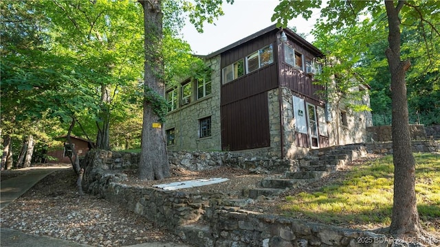 view of property exterior with stone siding