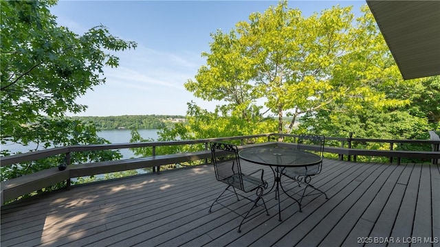 wooden terrace featuring a water view