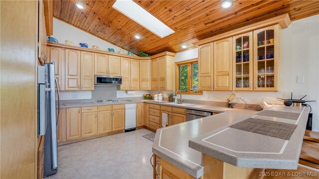 kitchen with wooden ceiling, light brown cabinets, a peninsula, a sink, and appliances with stainless steel finishes