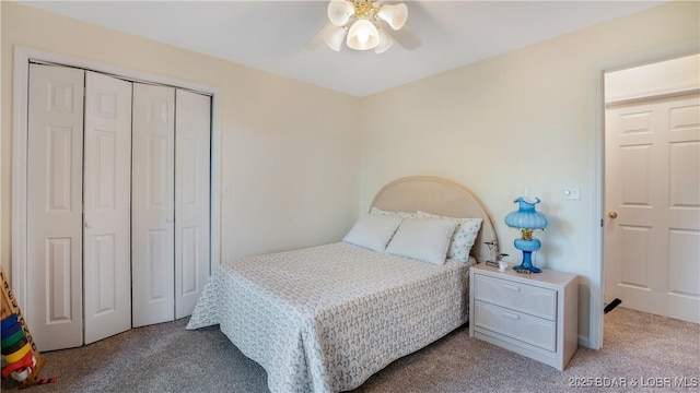 carpeted bedroom with a ceiling fan and a closet