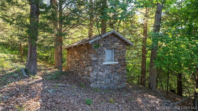 view of outdoor structure featuring an outdoor structure and a forest view