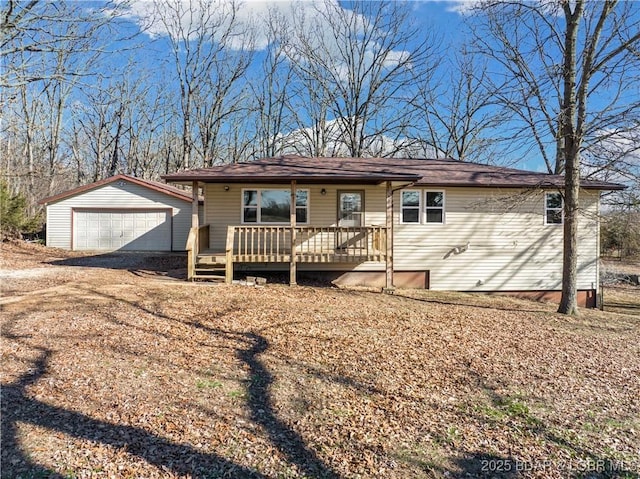 ranch-style home with an outdoor structure, a deck, and a detached garage