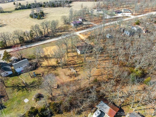 birds eye view of property with a rural view