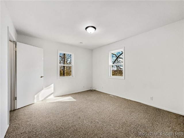 carpeted empty room with visible vents