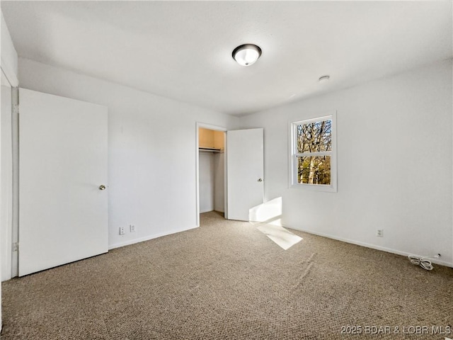 unfurnished bedroom featuring carpet floors, baseboards, and a closet