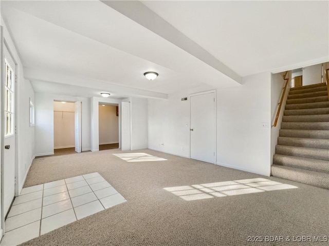 spare room with light carpet and stairs