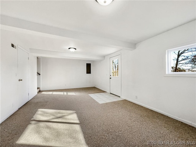 carpeted empty room with beam ceiling, plenty of natural light, and baseboards