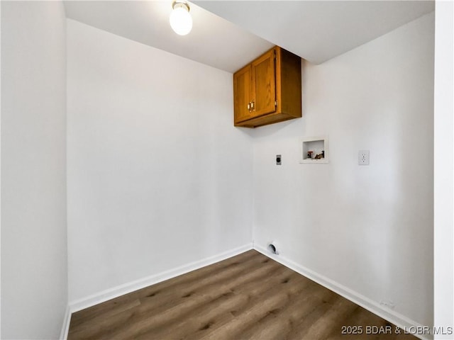 washroom featuring cabinet space, baseboards, dark wood-style flooring, hookup for a washing machine, and hookup for an electric dryer