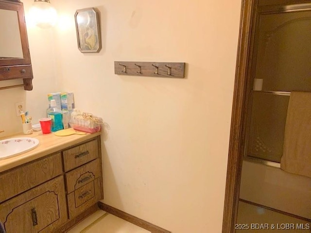 bathroom with vanity and baseboards