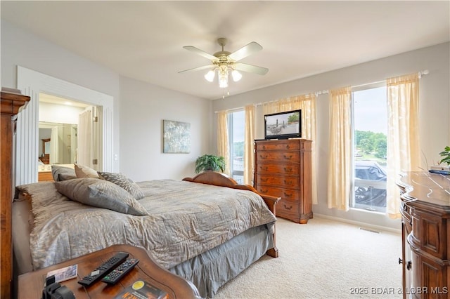 bedroom featuring light carpet, ceiling fan, visible vents, and baseboards