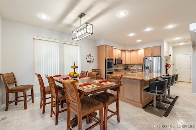 dining space featuring recessed lighting, light tile patterned flooring, and baseboards