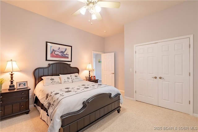 bedroom featuring a closet, light colored carpet, ceiling fan, and baseboards