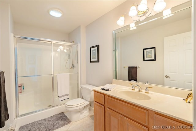 bathroom featuring tile patterned flooring, a shower stall, toilet, and vanity