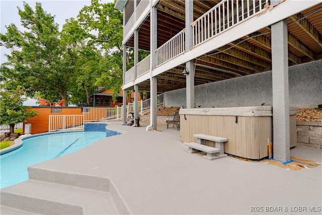 view of pool featuring a patio, a fenced in pool, and a hot tub