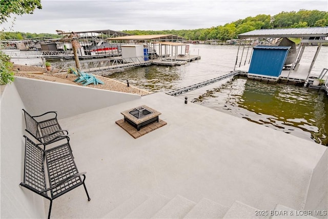 view of dock featuring a water view and a fire pit