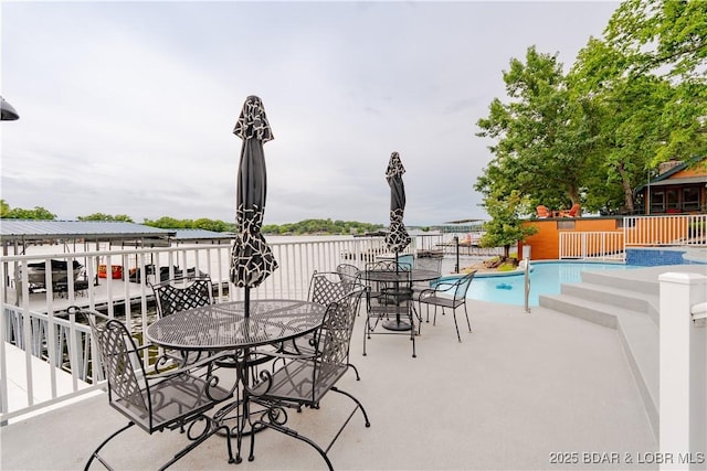 view of patio / terrace featuring outdoor dining area and a fenced in pool