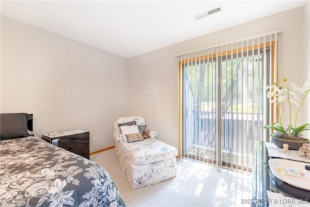 carpeted bedroom with access to outside and visible vents