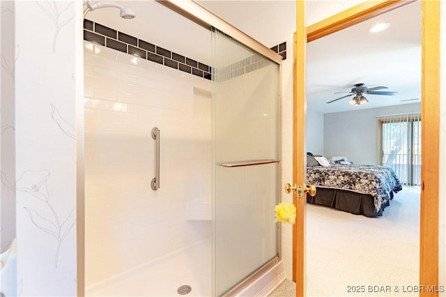 ensuite bathroom featuring a stall shower, connected bathroom, and a ceiling fan