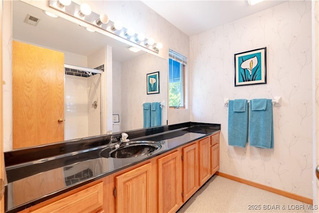 full bathroom featuring wallpapered walls, baseboards, visible vents, a shower, and vanity