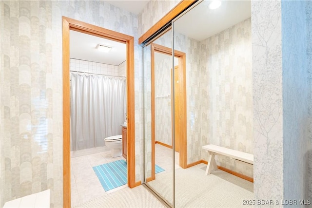 full bath with wallpapered walls, toilet, tile patterned floors, curtained shower, and vanity