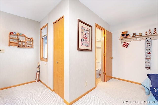 hall featuring light carpet and baseboards