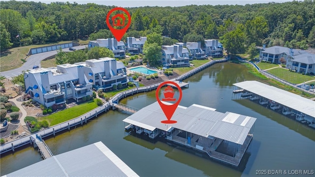 birds eye view of property featuring a water view and a view of trees