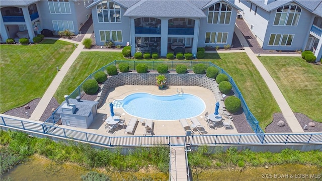 view of swimming pool with a patio area, a lawn, and a fenced backyard