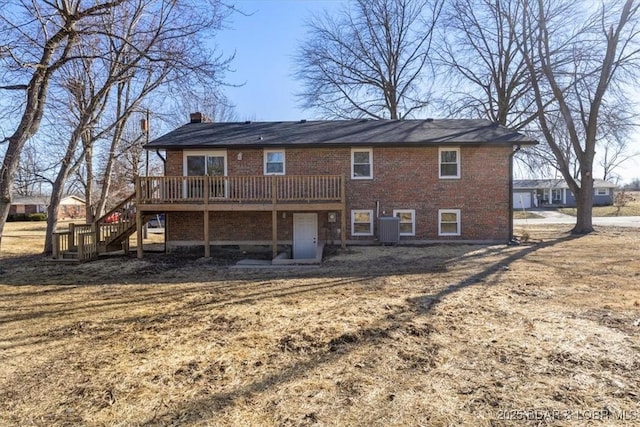 rear view of property with stairway, central AC unit, a chimney, a deck, and brick siding