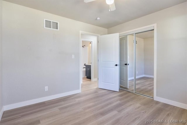 unfurnished bedroom with visible vents, light wood-style flooring, a closet, baseboards, and ceiling fan