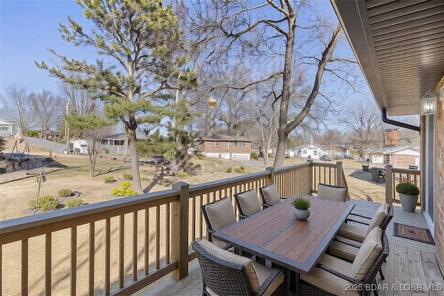 deck featuring a residential view and outdoor dining space