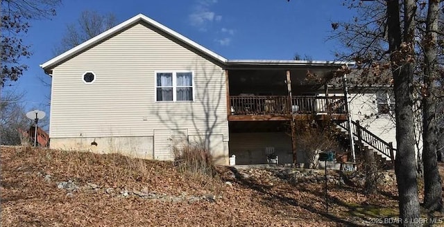 view of home's exterior featuring a deck and stairway