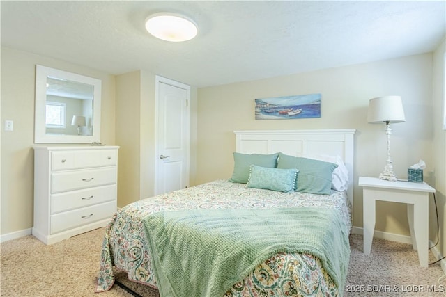 bedroom featuring carpet floors and baseboards