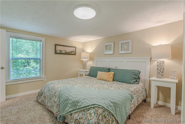 bedroom with carpet floors and baseboards