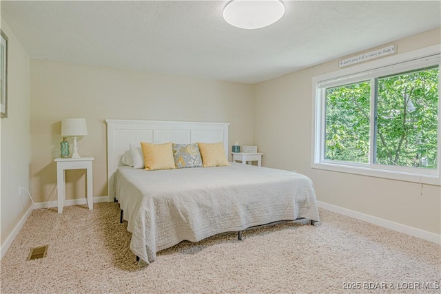 bedroom with visible vents and baseboards